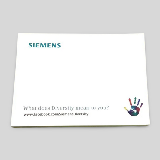 A rectangular notepad featuring the "Siemens" logo at the top left, with the question "What does Diversity mean to you?" printed at the bottom. A colourful handprint graphic is displayed on the lower right corner, alongside a link to facebook.com/SiemensDiversity, promoting diversity and inclusion. The clean design provides ample writing space, making it ideal for professional and corporate use.